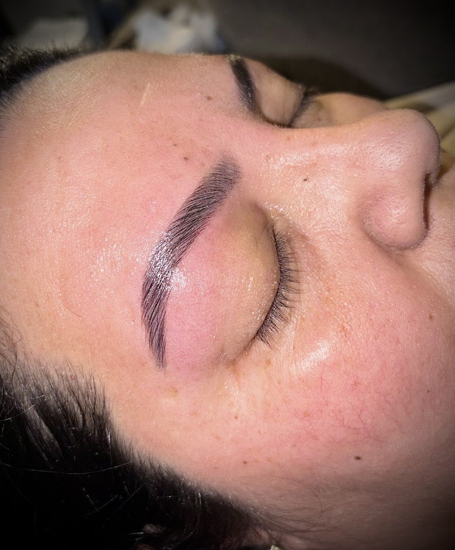 The same client's brows after lamination and tint, with a defined arch and a clean tail.