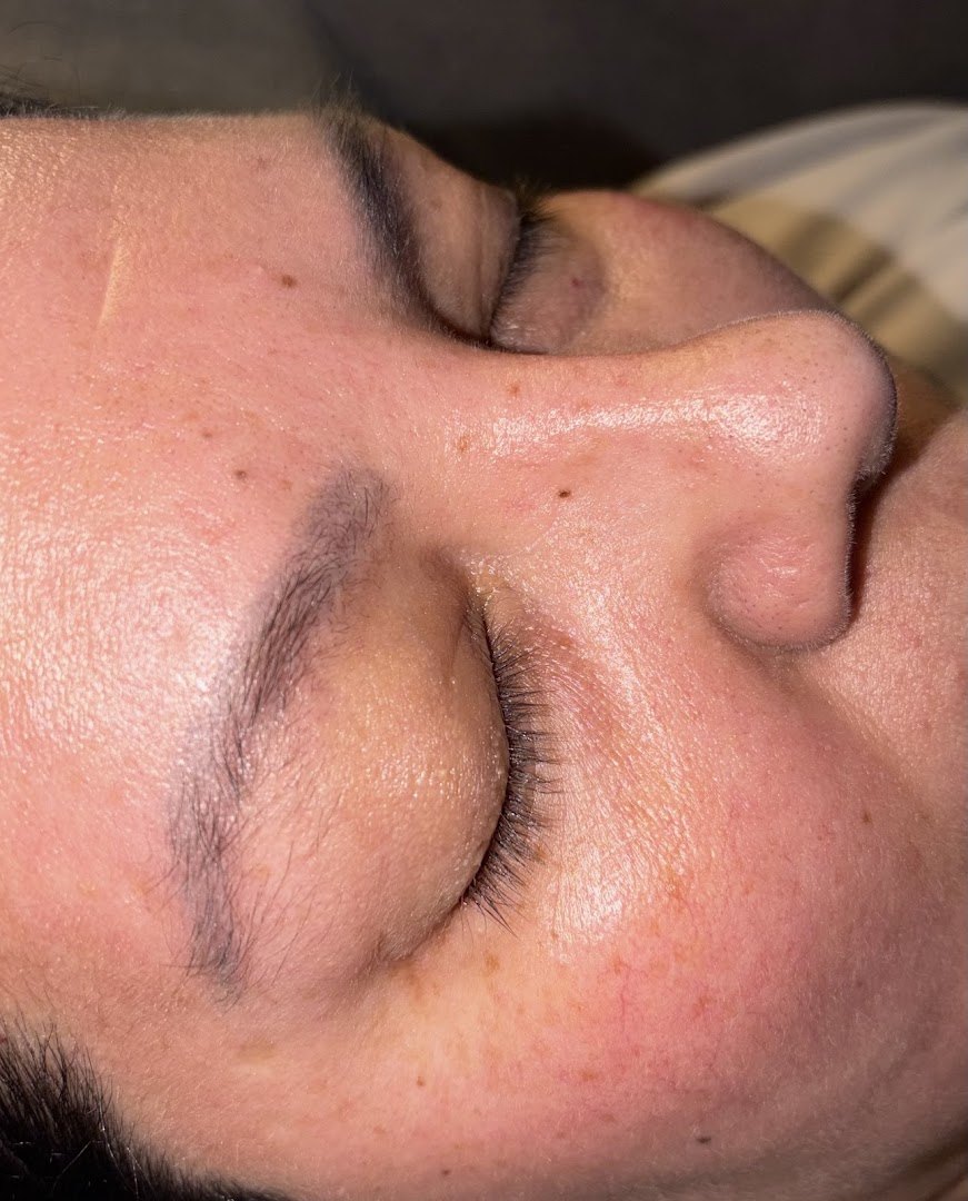 Client's natural brows before treatment, softly defined with a sparse tail.